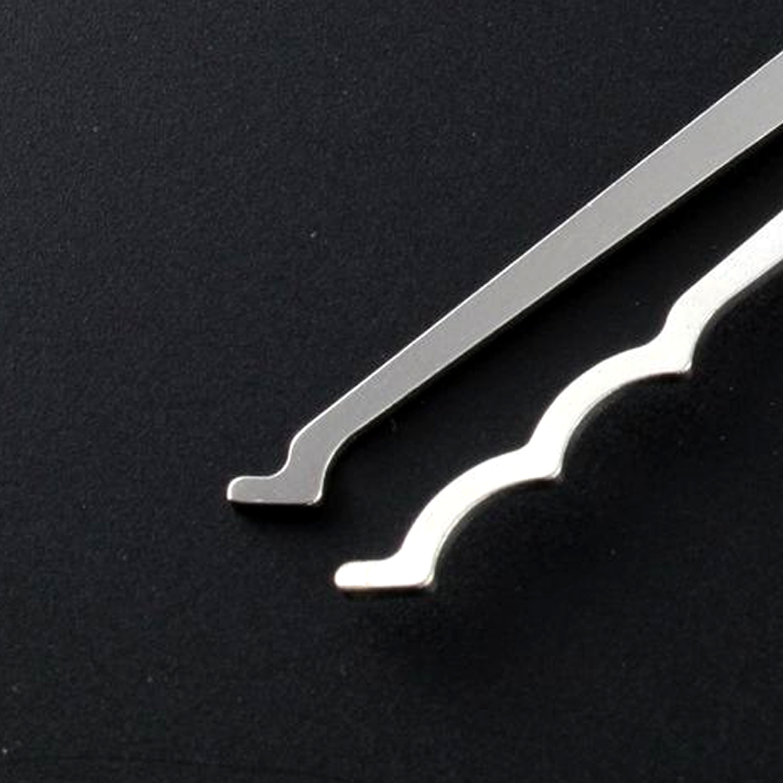 Close-up of Bogota Lock Rakes on plain black background.