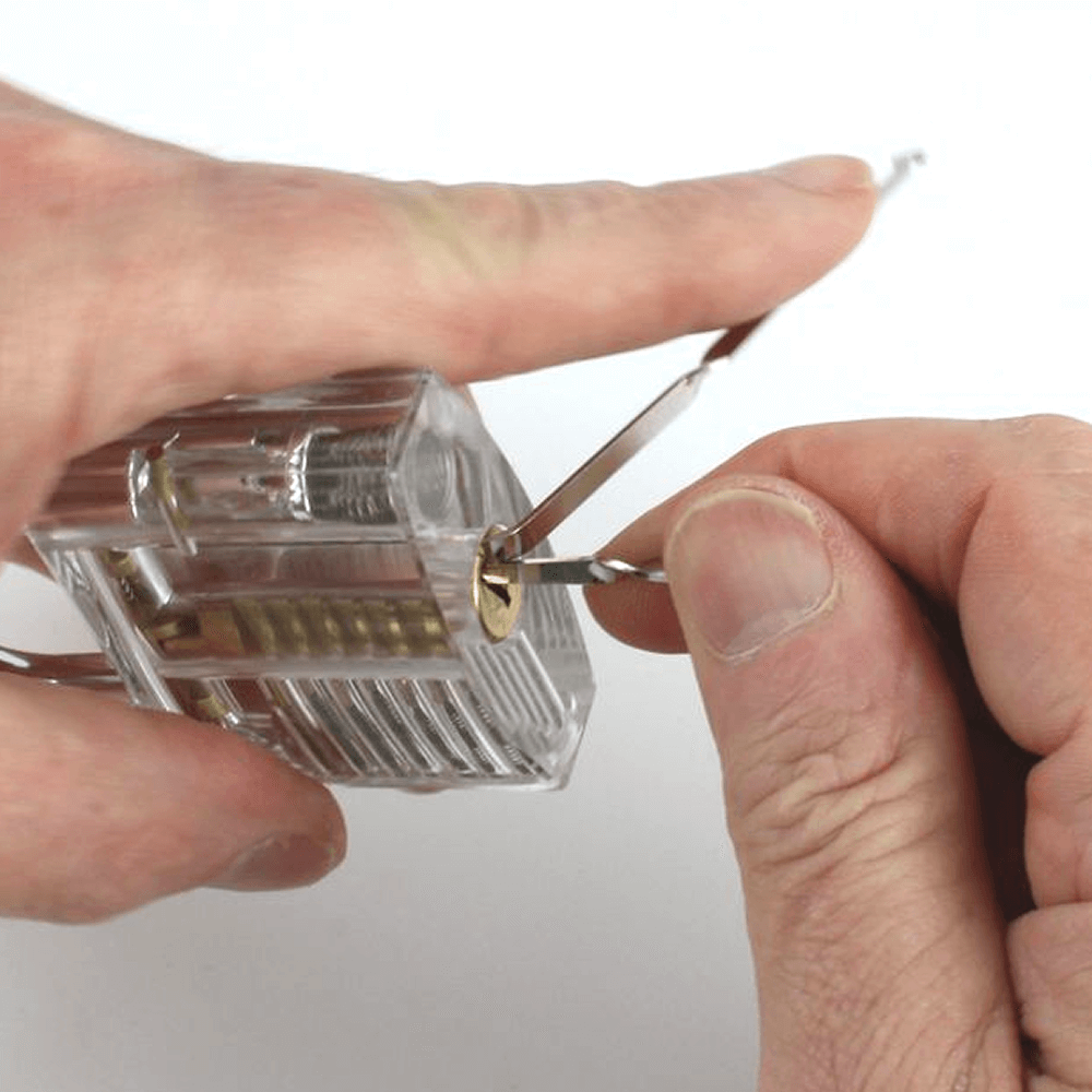 Person using Dangerfield Bogota Rakes to manipulate a clear padlock on a white background