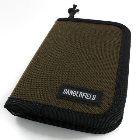 Dangerfield Jackal lock pick case closed at an angle, tan fabric with black binding and a woven Dangerfield label
