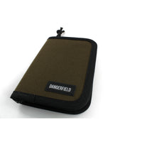 Dangerfield Jackal lock pick case closed at an angle, showing the 2.5 cm spine and the black paracord zip pull
