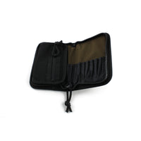 Dangerfield Jackal lock pick case open at an angle and empty, showing the tan interior panel and black tool pockets