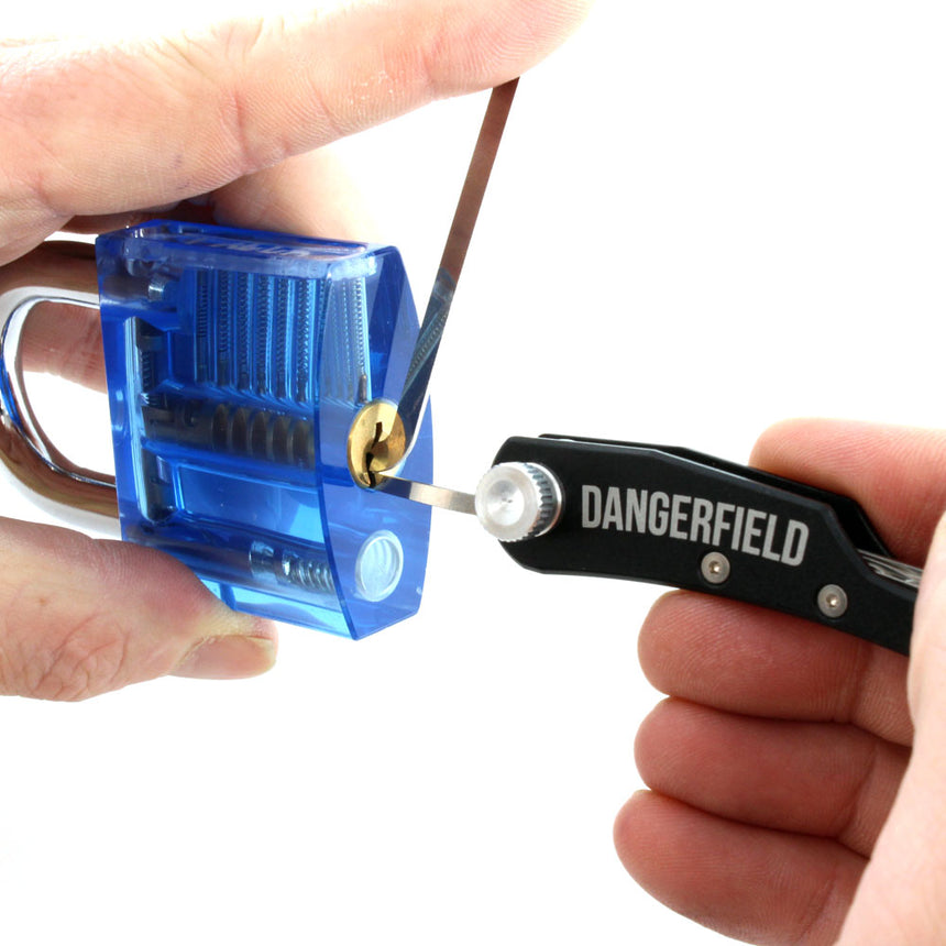 Dangerfield Skeleton lock pick tool in use on blue lock, showcasing portable EDC multi-tool capabilities and lightweight design.